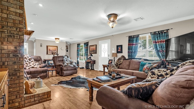 living room featuring ornamental molding, ceiling fan, and light hardwood / wood-style floors