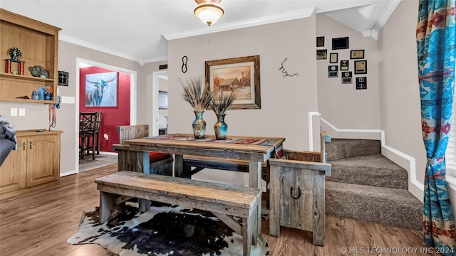 dining room with crown molding and wood-type flooring