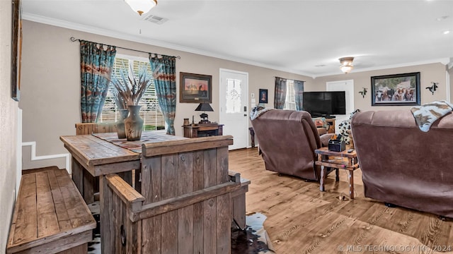 living room with light hardwood / wood-style floors and crown molding