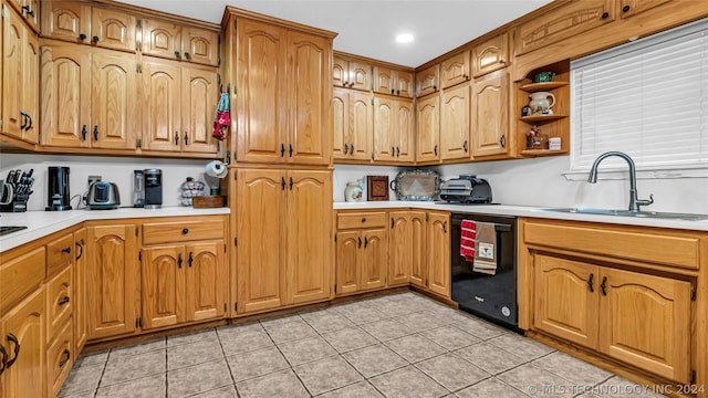 kitchen with light tile patterned flooring, dishwasher, and sink