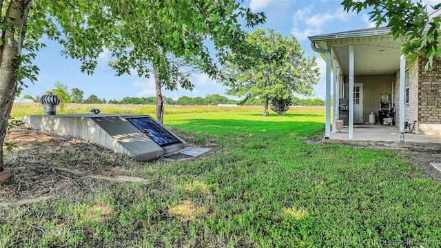 view of storm shelter featuring a lawn