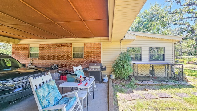 view of patio / terrace with an attached carport, outdoor dining area, and area for grilling