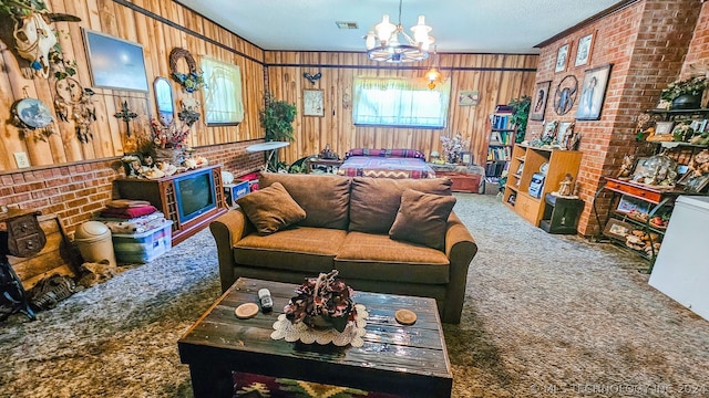 carpeted living area with wood walls, brick wall, visible vents, and a chandelier