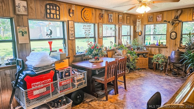 sunroom / solarium featuring a wealth of natural light and ceiling fan