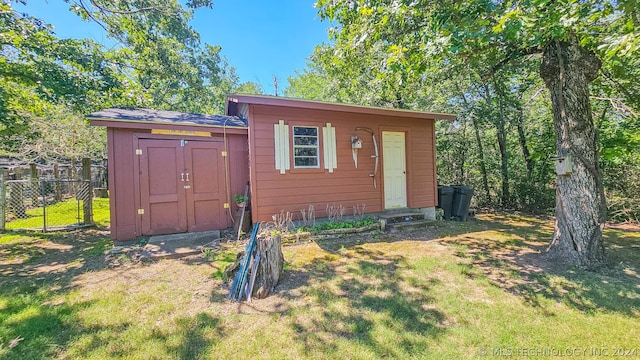 view of outbuilding featuring a yard