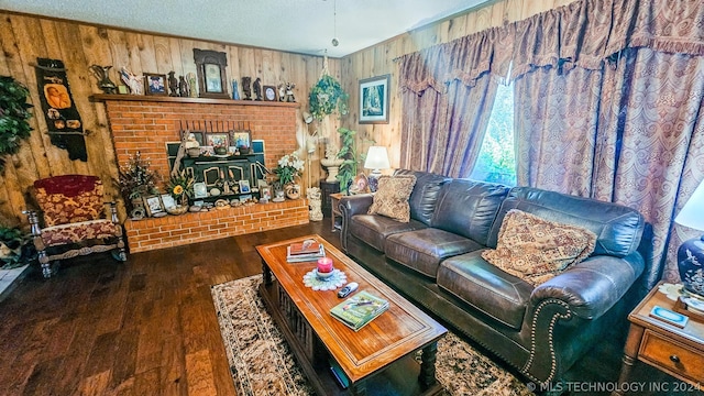 living area with a textured ceiling, wood finished floors, and wooden walls