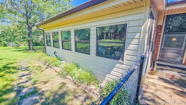 view of home's exterior with a yard