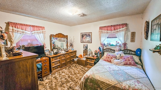 carpeted bedroom with a textured ceiling