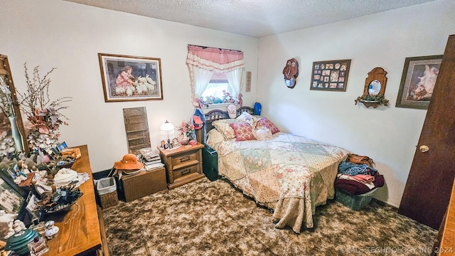 bedroom featuring a textured ceiling and carpet