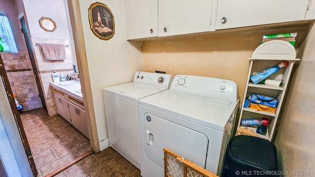 laundry room featuring cabinets, separate washer and dryer, and sink