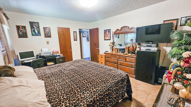 bedroom featuring light tile patterned floors and a textured ceiling