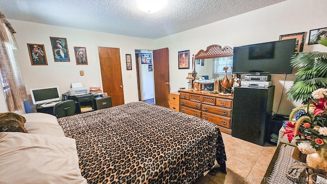 bedroom with a textured ceiling and light tile patterned flooring