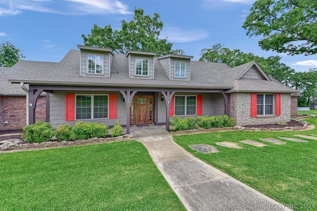 view of front of property with covered porch and a front lawn