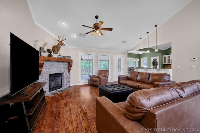 living room with ceiling fan, a brick fireplace, wood-type flooring, lofted ceiling, and ornamental molding