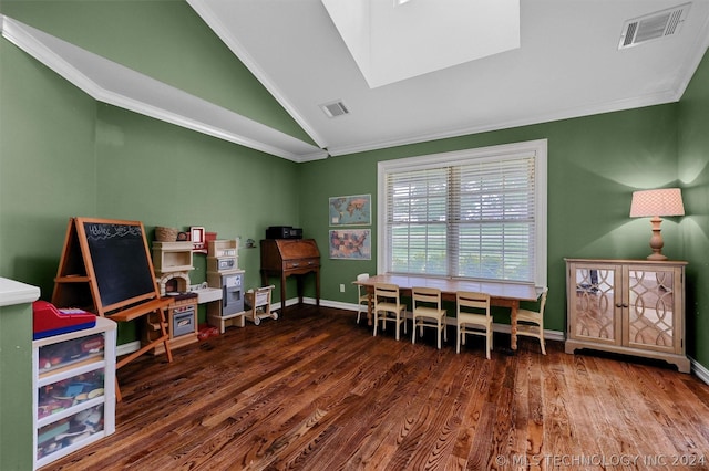 rec room featuring dark wood-type flooring, crown molding, and vaulted ceiling with skylight