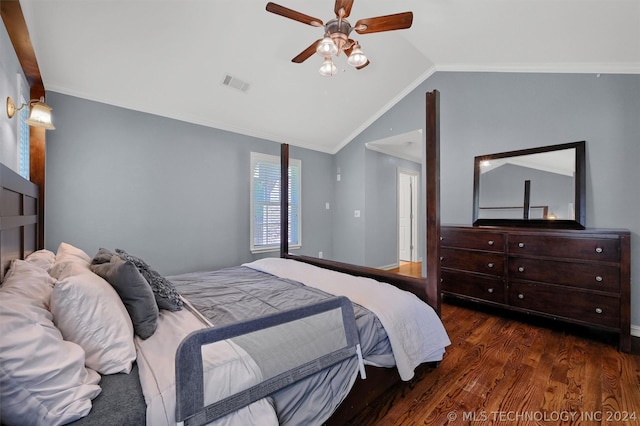 bedroom featuring ceiling fan, dark hardwood / wood-style flooring, lofted ceiling, and ornamental molding