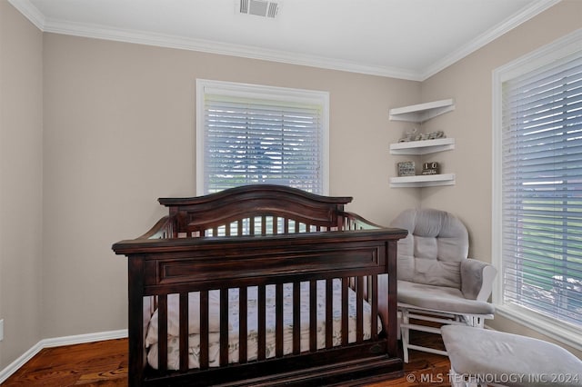 bedroom featuring dark hardwood / wood-style floors and ornamental molding