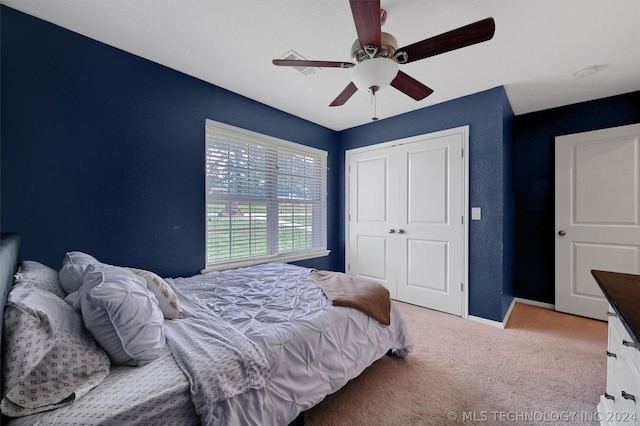 bedroom with light carpet, a closet, and ceiling fan