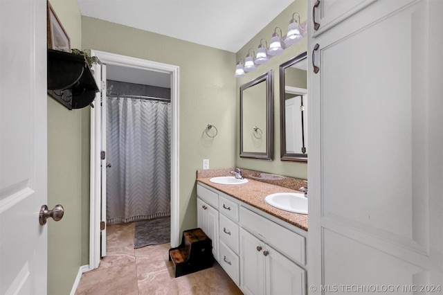 bathroom featuring tile patterned flooring and vanity