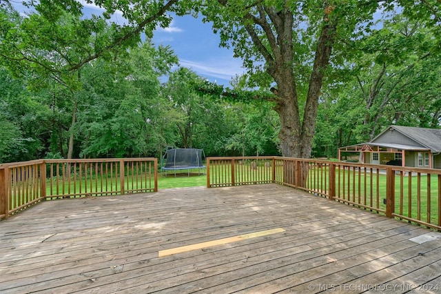 deck featuring a yard and a trampoline