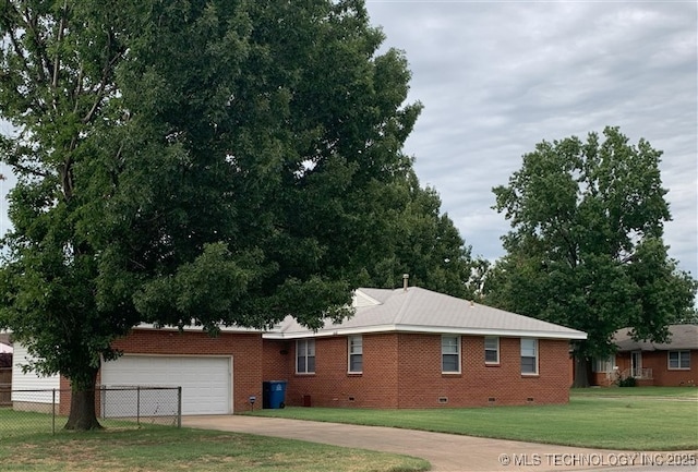 view of side of home with a garage and a yard