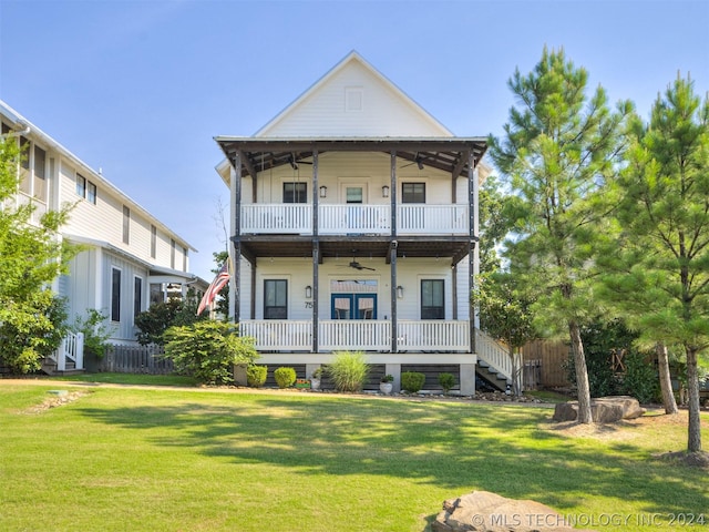 view of front of home with covered porch, ceiling fan, a balcony, and a front lawn