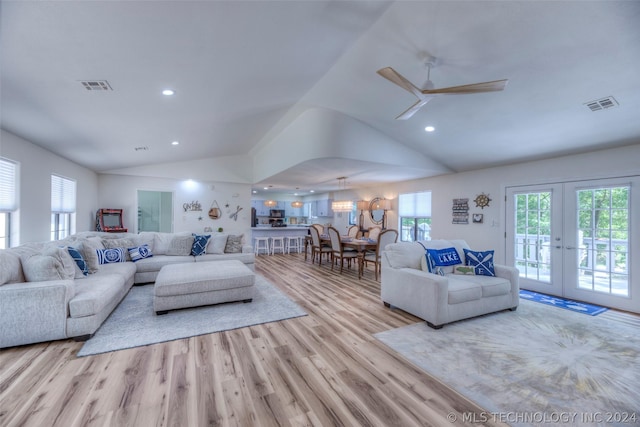 living room with lofted ceiling, ceiling fan, french doors, and light hardwood / wood-style floors