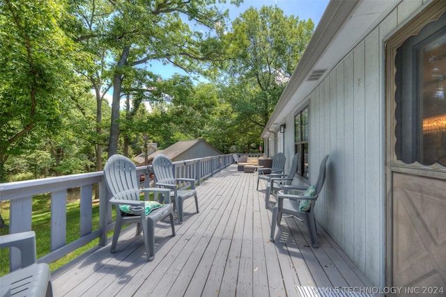 wooden terrace with an outdoor hangout area