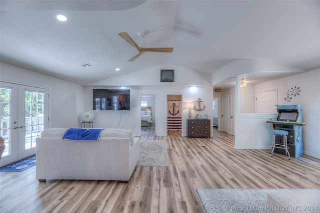 living room featuring ceiling fan, light hardwood / wood-style flooring, french doors, and vaulted ceiling