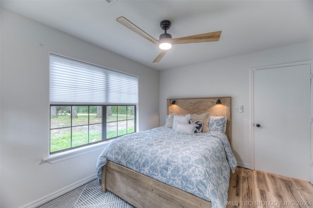 bedroom with ceiling fan and light hardwood / wood-style flooring