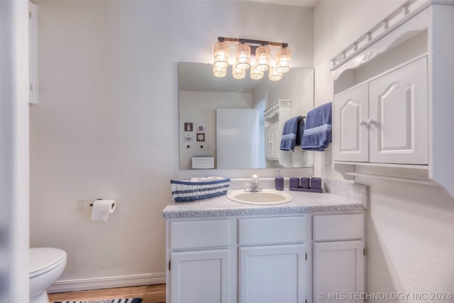 bathroom featuring toilet and vanity