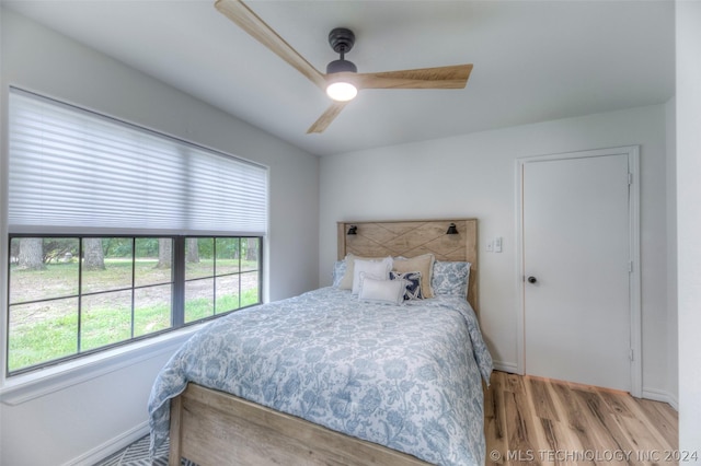 bedroom with ceiling fan and light hardwood / wood-style floors