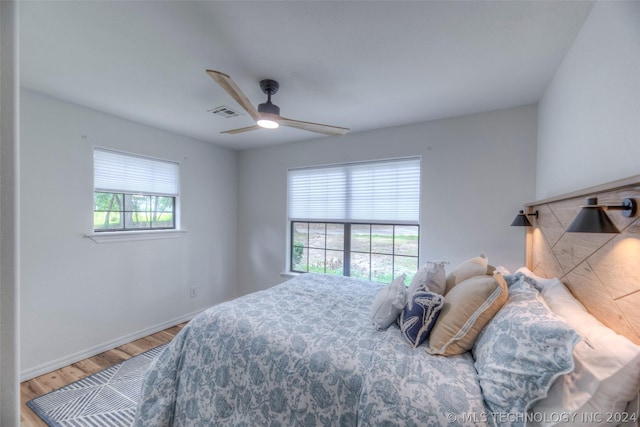 bedroom with ceiling fan and wood-type flooring