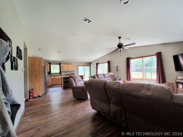 living room with vaulted ceiling, dark hardwood / wood-style flooring, ceiling fan, and plenty of natural light