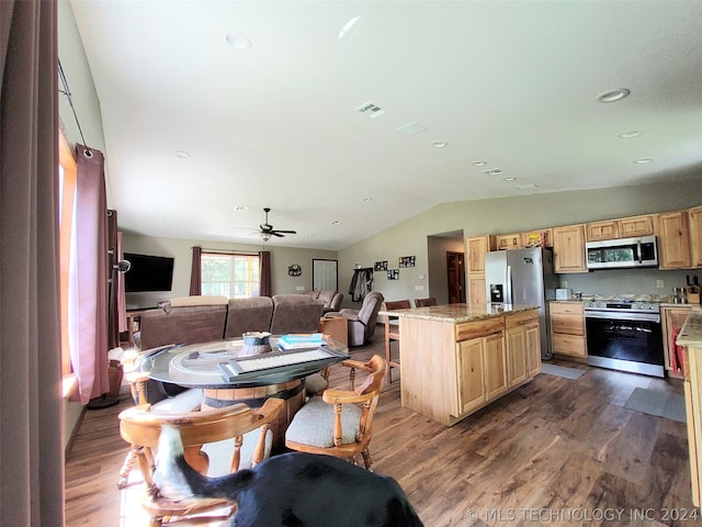 dining space featuring ceiling fan, lofted ceiling, and dark wood-type flooring