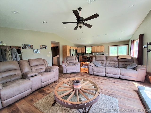 living room with ceiling fan and light hardwood / wood-style flooring