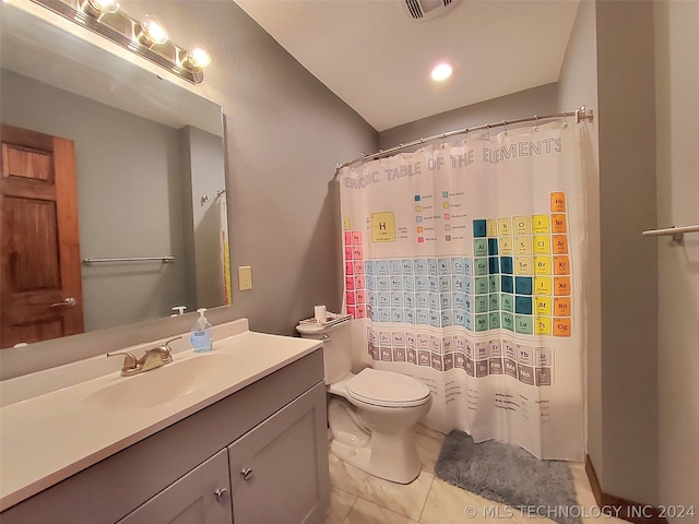 bathroom featuring tile flooring, vanity, and toilet