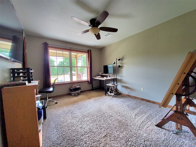 carpeted office space with ceiling fan