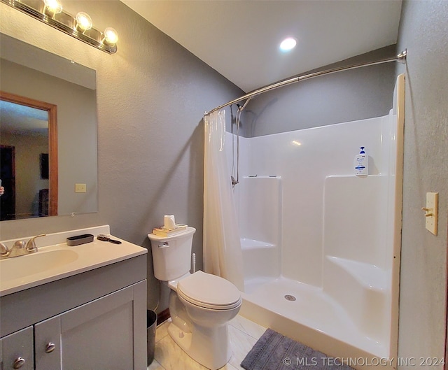 bathroom with a shower with curtain, vanity with extensive cabinet space, toilet, and tile floors