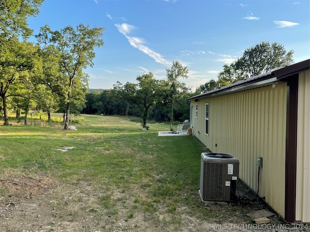 view of yard featuring central air condition unit