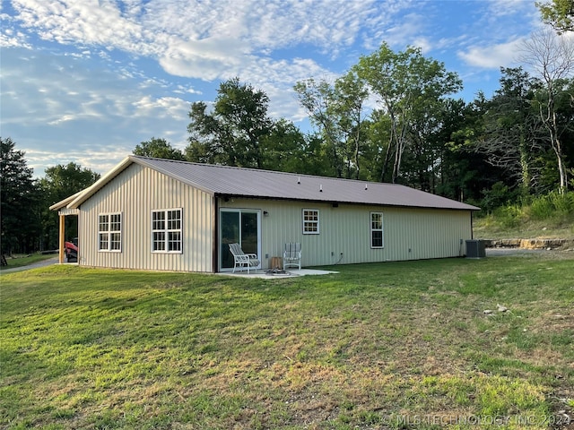 back of property featuring a patio and a lawn