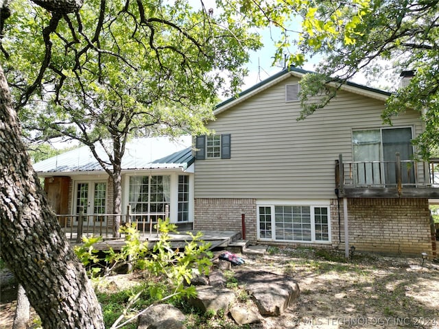 back of house with a wooden deck