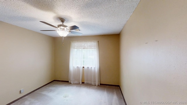 unfurnished room featuring a textured ceiling, light colored carpet, and ceiling fan