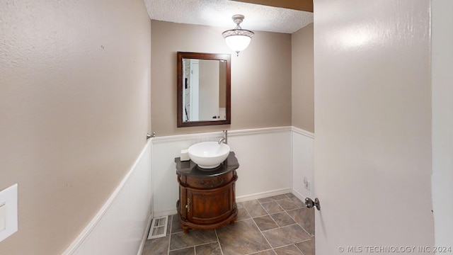 bathroom with vanity and a textured ceiling