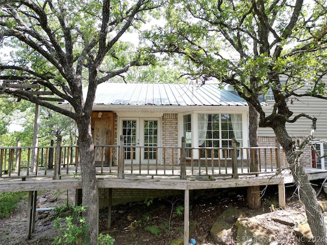 back of property featuring a wooden deck and french doors