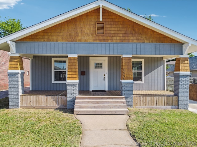 bungalow featuring a front yard and a porch