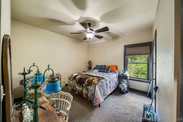 bedroom with carpet flooring, ceiling fan, and a textured ceiling