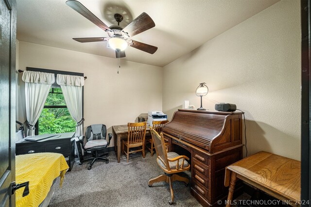 carpeted home office with ceiling fan