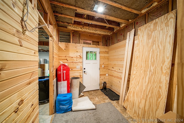 interior space with wooden walls and tile flooring