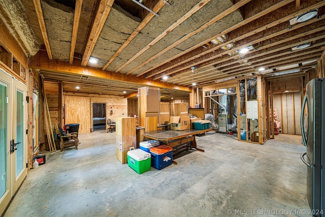 basement featuring stainless steel refrigerator